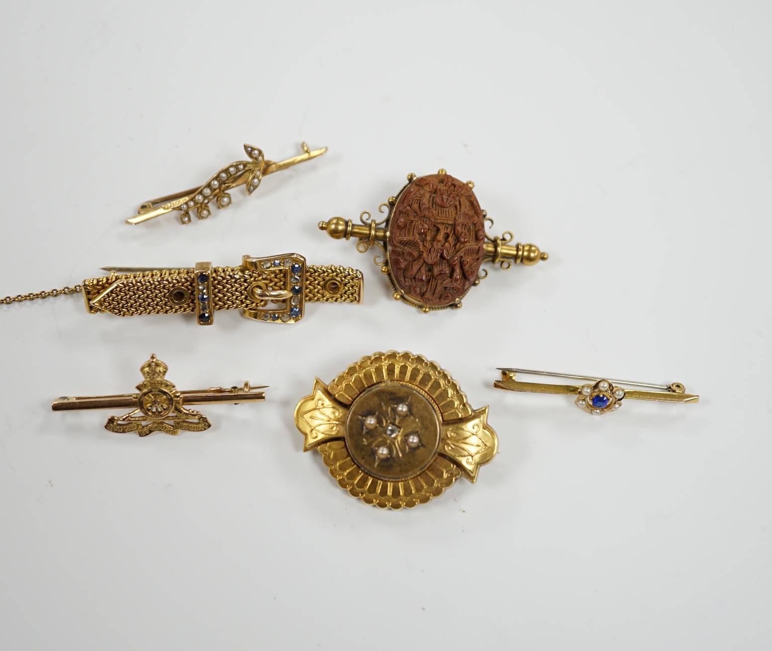 Four assorted yellow metal and gem set bar brooches including sapphire and diamond chip set buckle brooch, 51mm and two other yellow metal brooches, one set with diamond and split pearl